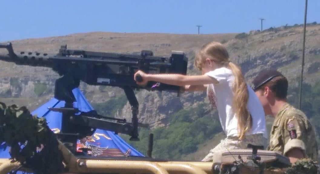 Soldiers inviting a child to handle a gun at Llandudno in 2018