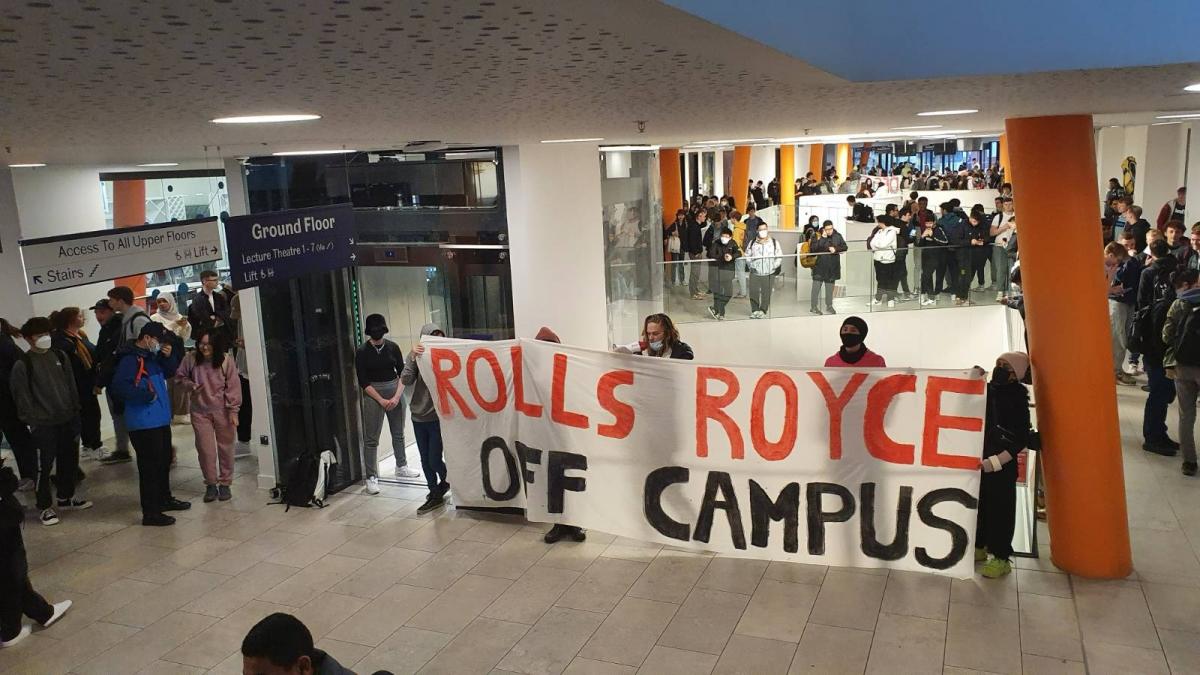 Students protesting at Sheffield University with a banner reading "Rolls Royce off campus"