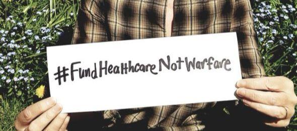 Poster reading, 'Fund Healthcare Not Warfare'