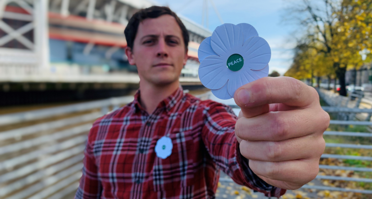 Rhun Dafydd displays a white poppy in Cardiff last weekend