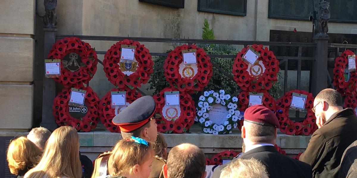 White poppy wreath among the red poppy wreaths in Bath on Sunday